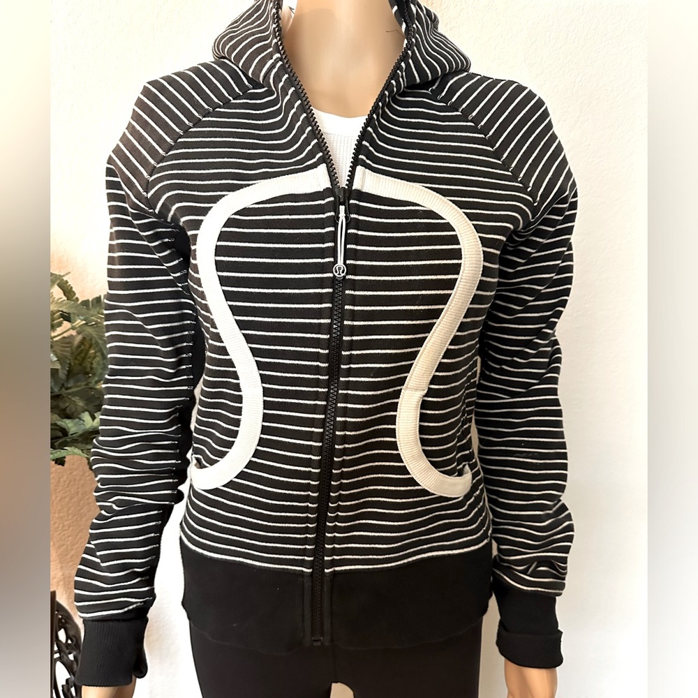 Lululemon jacket with hood and pockets. Black and white stripes with large logo.